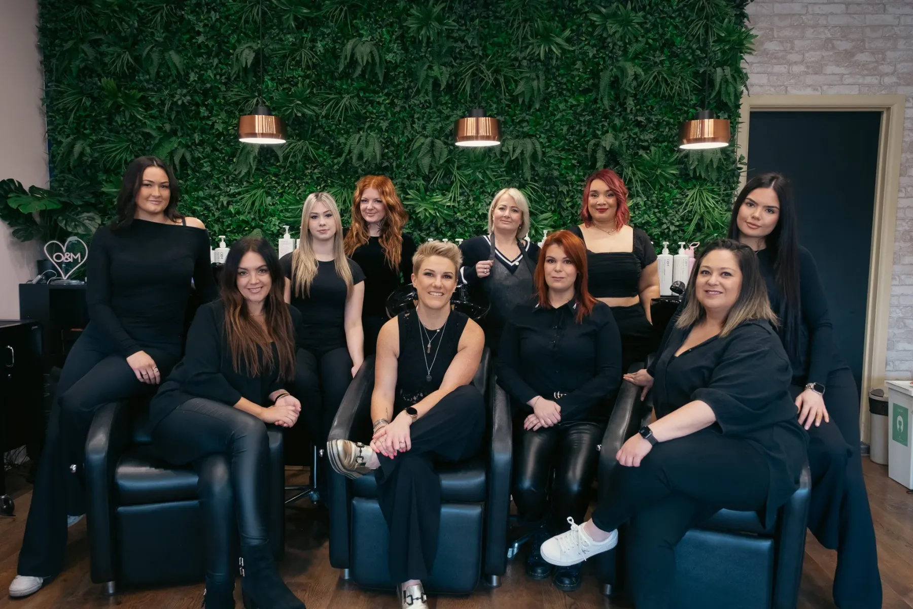 The Satori Hair team in front of the living green wall at Kingsville, Melbourne